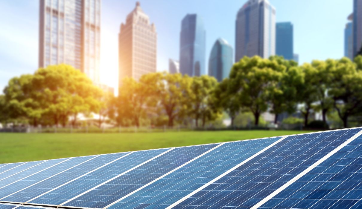 Solar panels with a city skyline in the background