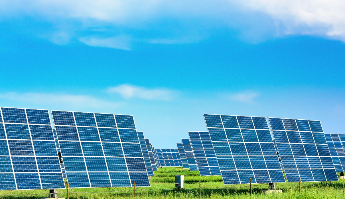 Solar panels at dramatic sunset with warm orange sky