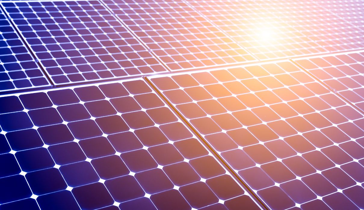 Close-up detail of solar panel cells with warm sunlight